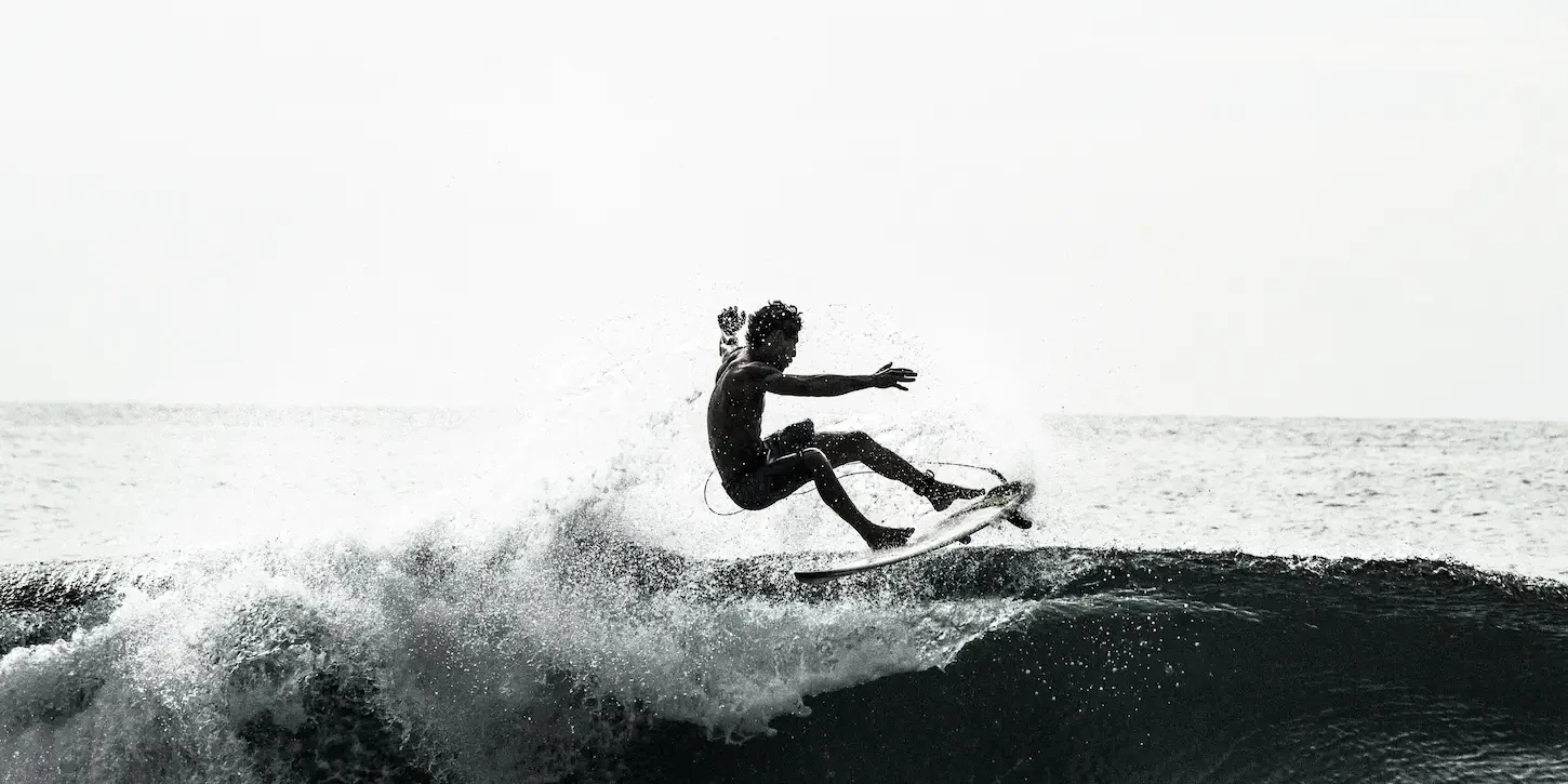 Black and white photograph of man surfing